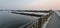 Sand tanker cargo ship sailing smoothly river in evening before sunset