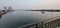 Sand tanker cargo ship sailing smoothly river in evening before sunset