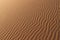 Sand texture - background of desert sand dunes. Beautiful structures of sandy dunes. sand with wave from wind in desert