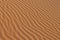 Sand texture - background of desert sand dunes. Beautiful structures of sandy dunes. sand with wave from wind in desert