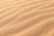 Sand texture - background of desert sand dunes. Beautiful structures of sandy dunes. sand with wave from wind in desert