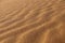 Sand texture - background of desert sand dunes. Beautiful structures of sandy dunes. sand with wave from wind in desert