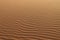 Sand texture - background of desert sand dunes. Beautiful structures of sandy dunes. sand with wave from wind in desert