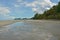 Sand wave with water on the beach beside the shore