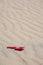 Sand weaves and a red plastic shovel