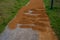 Sand wheeling. garden wheelbarrow carries a worker and pours on piles of beige gravel to repair park, forest, dirt road. erosion c