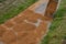 Sand wheeling. garden wheelbarrow carries a worker and pours on piles of beige gravel to repair park, forest, dirt road. erosion c