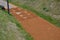 Sand wheeling. garden wheelbarrow carries a worker and pours on piles of beige gravel to repair park, forest, dirt road. erosion c