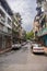 Sandakan, Malaysia - January 06, 2022: Cityscape of the in Borneo. Rundown houses and old Malaysian cars on the street. Second