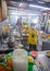 Sandakan, Malaysia - January 6, 2022: Inside the kitchen of a Chinese street food restaurant. Woman shows the peace sign. Typical