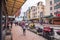 Sandakan, Malaysia - January 6, 2022: Shopping street with open shops in the city center the town in Sabah. The goods hang outside