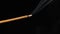 Sandalwood stick with incense smokes on a black background