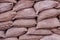 Sandbag flood protection wall texture. Background of lying grey sandbags. Bags to strengthen the defensive structure during the