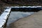 Sandbags ripped from the side of the road protect against flood waves or torrential rains during the monsoon. the water is directe