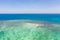 Sandbar on a coral reef. Atoll with a small sandy island