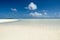 Sandbar flooded with clear water, blue sky with white clouds, very small island in Southern Pacific Ocean, Aitutaki, Cook Islands