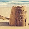 Sandcastle on a beach and the text summer break