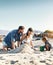 Sandcastle, holiday and children at the beach with family, love and support. Baby, mom and dad together with kids