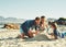 Sandcastle, parents and children at the beach with bonding, love and support. Baby, mom and dad together with kids