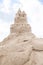 Sandcastle at skies background in Baltic sea.