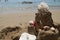 Sandcastle with starfish, coral and seashell on sandy beach