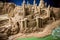 sandcastle surrounded by a detailed moat system