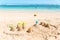 Sandcastles on a beach with the sea in the background.