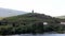 Sandeman silhouette on a hill over vineyards, across Douro River, Peso da Regua, Portugal