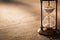 A sandglass, modern hourglass or egg timer with shadow showing the last second or last minute or time out.