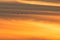 Sandhill cranes in flight backlit silhouette with golden yellow and orange sky at dusk / sunset during fall migration at the Crex