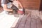Sanding hardwood floor with the grinding machine. Repair in the apartment, country house,patio. Carpenter doing parquet
