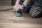 Sanding process of wooden terrace floors. Sanding machine remove imperfections.