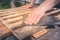 sanding a wooden surface/man`s hand processes a wooden surface with sandpaper