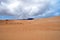 Sands, mountains and clouds over them