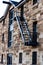 Sandstone brick building exterior with stairway fire exit