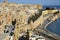 Sandstone buildings in the old harbor and Victoria Gate in Valetta