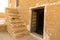 Sandstone buildings with stairs and low doors in Kumbalgarh Jaisalmer