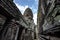 Sandstone carvings depicting a person\\\'s face on a walkway in Bayon Temple in Angkor Thom, Siem Reap