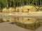 Sandstone cliffs on the seashore, beautiful reflections in the water