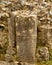 Sandstone columns in flint stone wall ruins, textured background