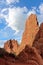 Sandstone rock pinnacle formations rising up against a blue sky with cumulus clouds at the Garden of the Gods in Colorado