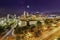 Sandton City at night illuminated buildings with moon and stars in the sky