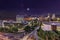 Sandton City skyline lit up at night with moon and stars in the sky