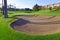 Sandtrap and Mancured grass of golf course