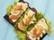 Sandwich with avocado red fish lunch lemon gourmet blue wooden appetizer rustic