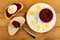 Sandwich with beetroot and egg, spoon on piece of bread, bowl with beetroot caviar, slices of boiled egg in plate on table. Top