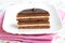Sandwich biscuit with layered chocolate, halved