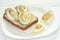 Sandwich with bread butter and eggs with mayonnaise on a white plate and white background, close-up