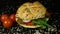 Sandwich, burger with fresh vegetables, cheese, ham, radish, onion leaves, plum tomatoes, seven-grain bread. Breakfast, lunch