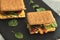 Sandwich with cereals bread and salmon on dark marble background
